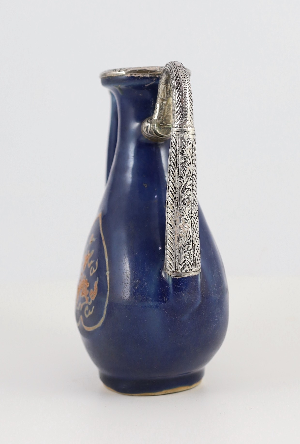 A Chinese late Ming blue glazed and slip decorated ‘qilin’ ewer, for the Islamic market, 20cm high, later Islamic silver mounts, wear